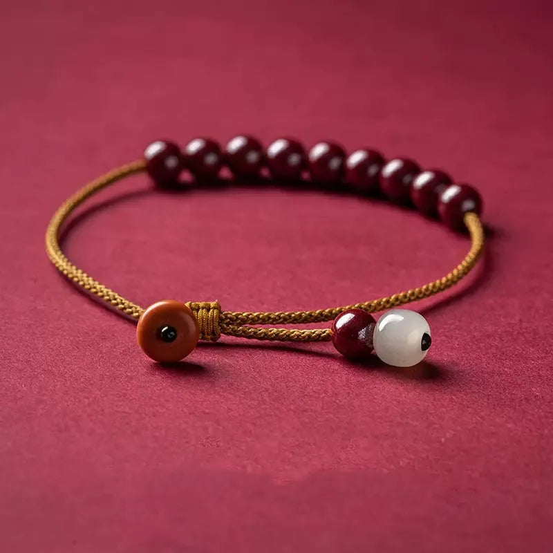 Hand-woven geometric bracelet made from raw cinnabar and Hetian jade beads