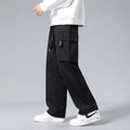Boy wearing army green straight leg cargo pants with large pockets and a drawstring waist.