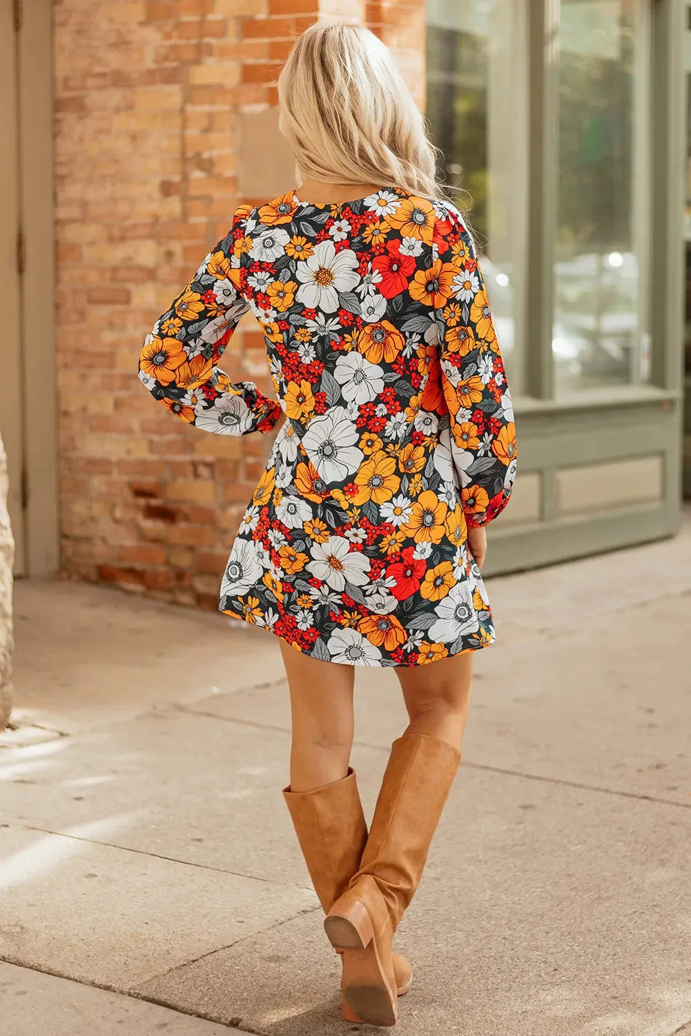 Orange floral print mini dress with V-neck, long sleeves, and striped lace detailing