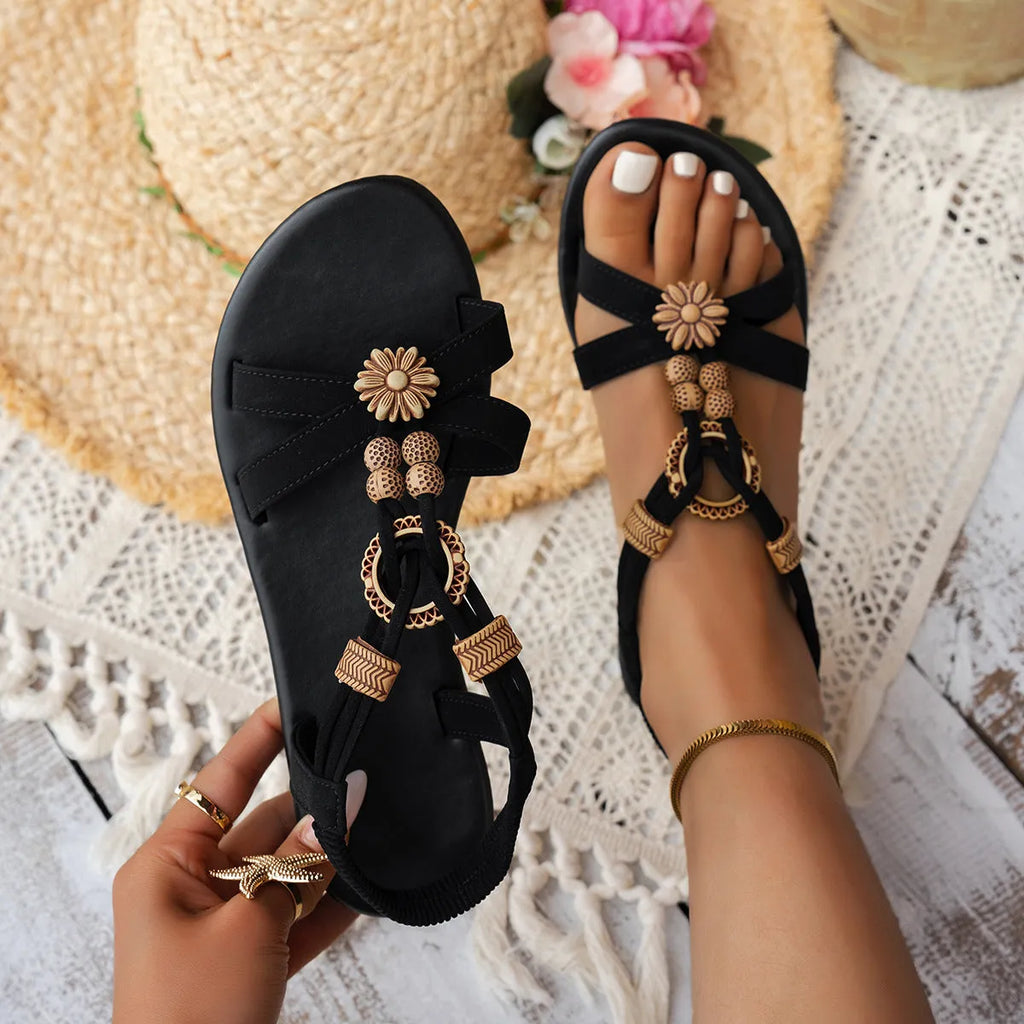 Black ethnic style flat women's sandals with beaded weave, rhinestone decorations, and an elastic band.