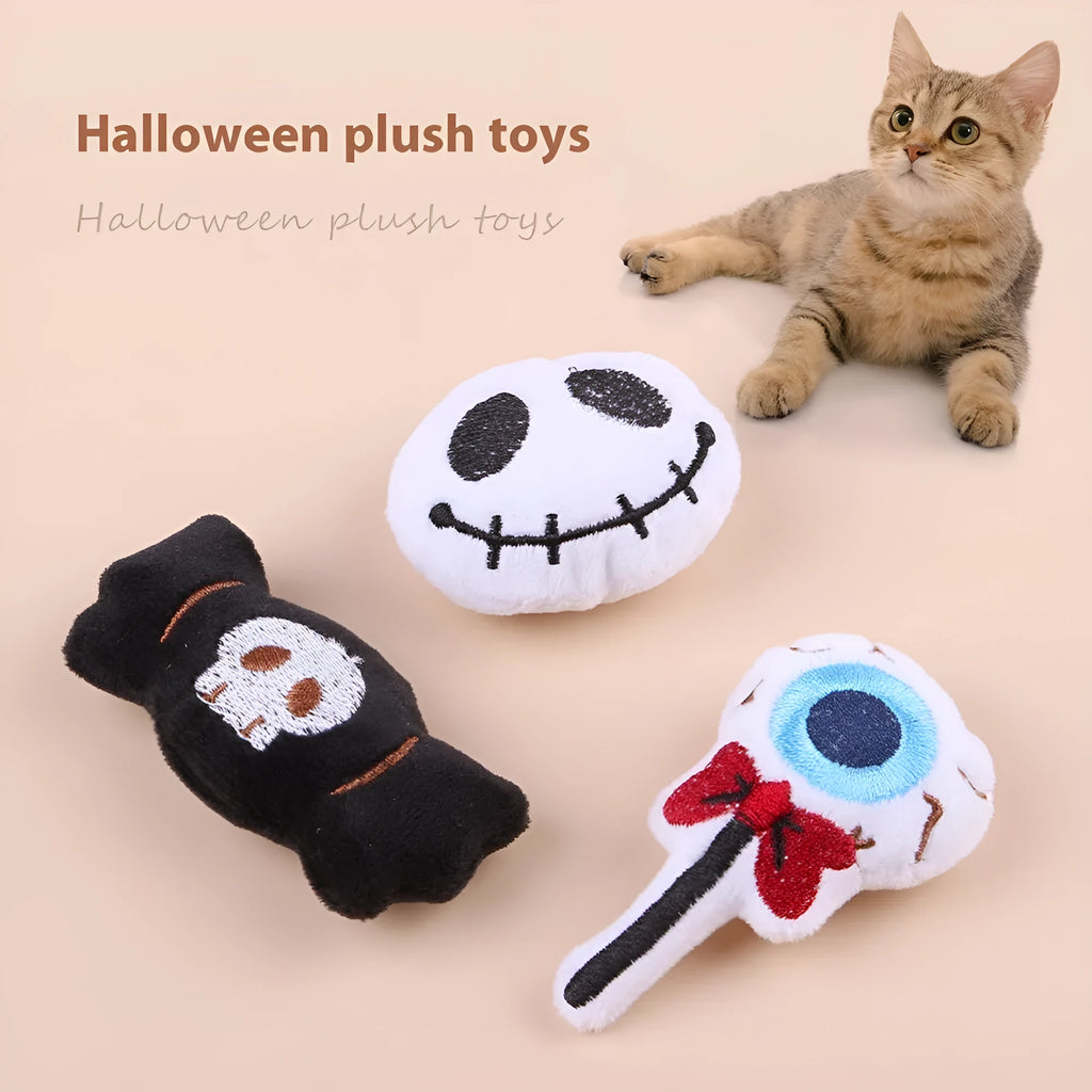 Small cat teaser toy with eyes, candy and skull plush designs on lightweight wand