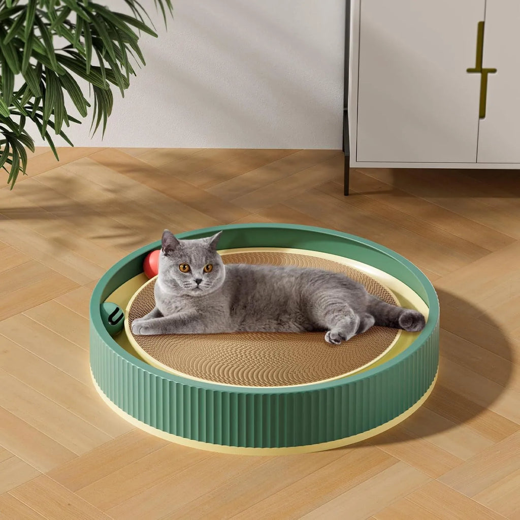 Large circular green cat scratching board with ball toys and a replaceable cardboard core