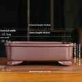 Purple sand rectangular bonsai planter with corner cutting design on wooden surface