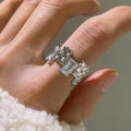Open geometric zircon ring with three-dimensional decoration in silver colour