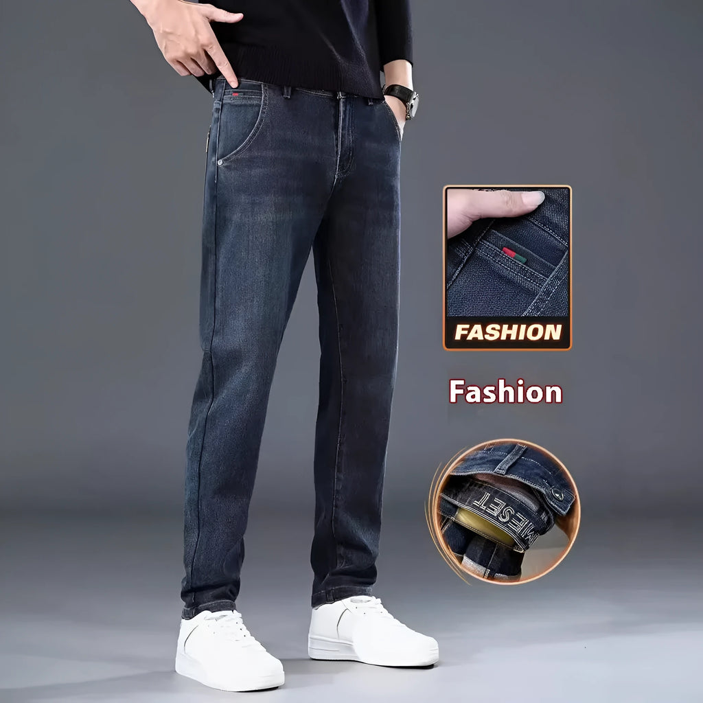 Man wearing slim straight blue grey casual trousers with a zip fly and mid waist.