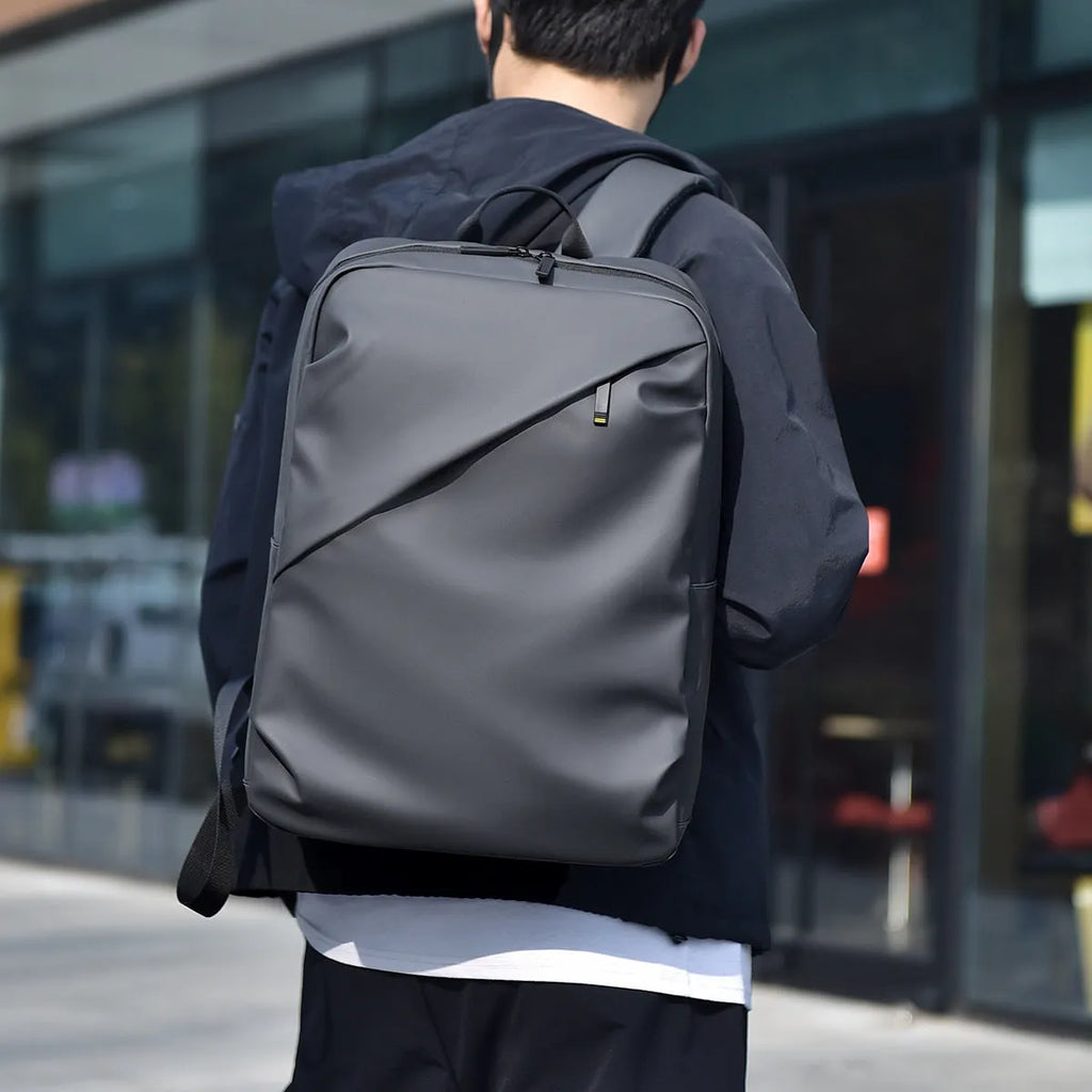 Large waterproof backpack in PU leather with sewing thread detailing and computer bag