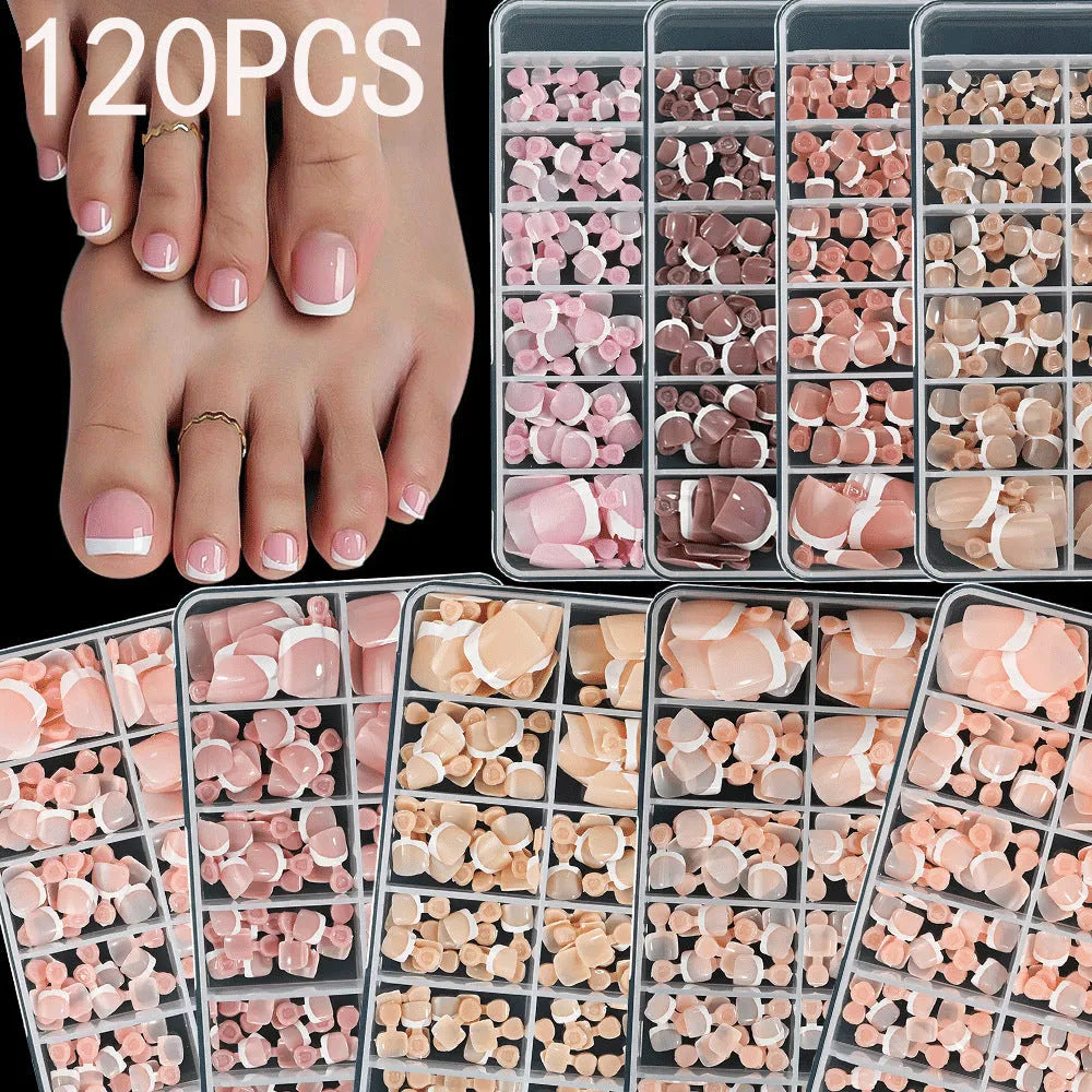 Box of 120 short square false toenails with French white tips, showing nine nude colour options from light to dark.