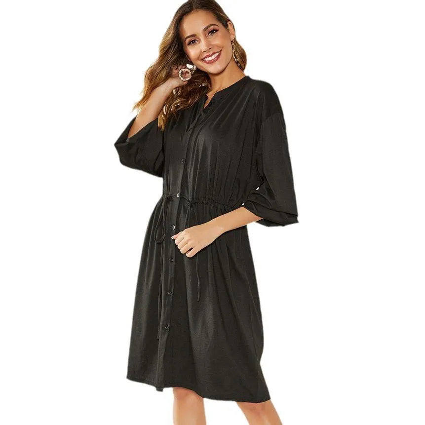 Women's black A-line midi dress with elastic waist, long sleeves, and cinched belt detail