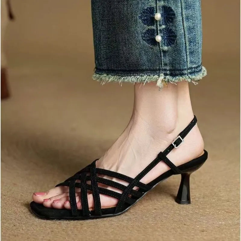 Retro beige high heel sandals with thin cross straps and an ankle buckle on a square toe.