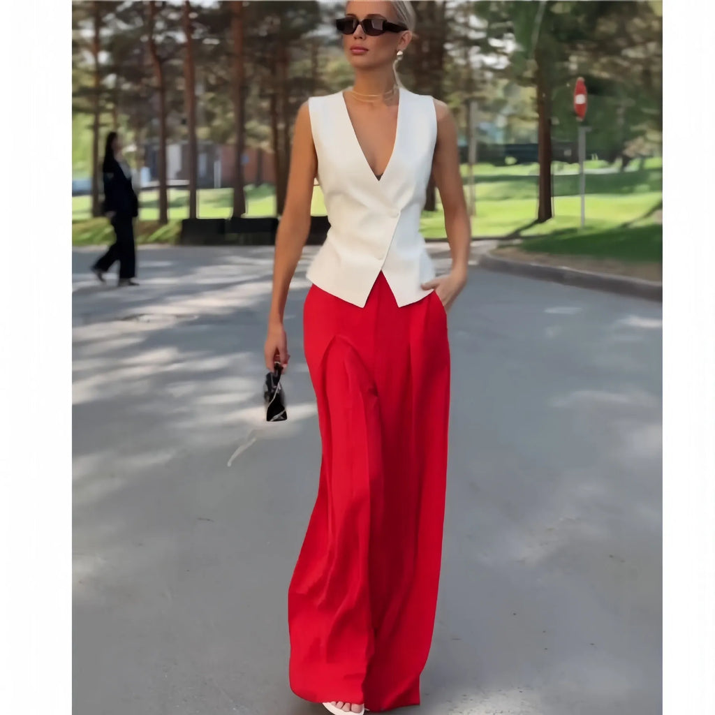 Women's beige two-piece set with deep V-neck sleeveless top and high-waist wide-leg trousers.
