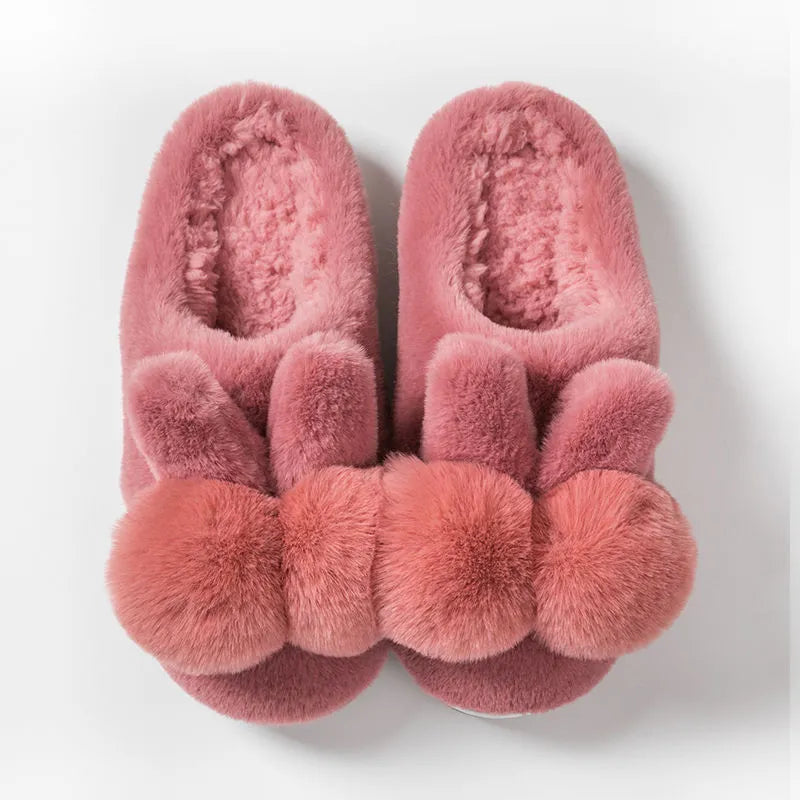 Women's fluffy pink rabbit fur winter slippers with a high overshoe design and sewn sole.