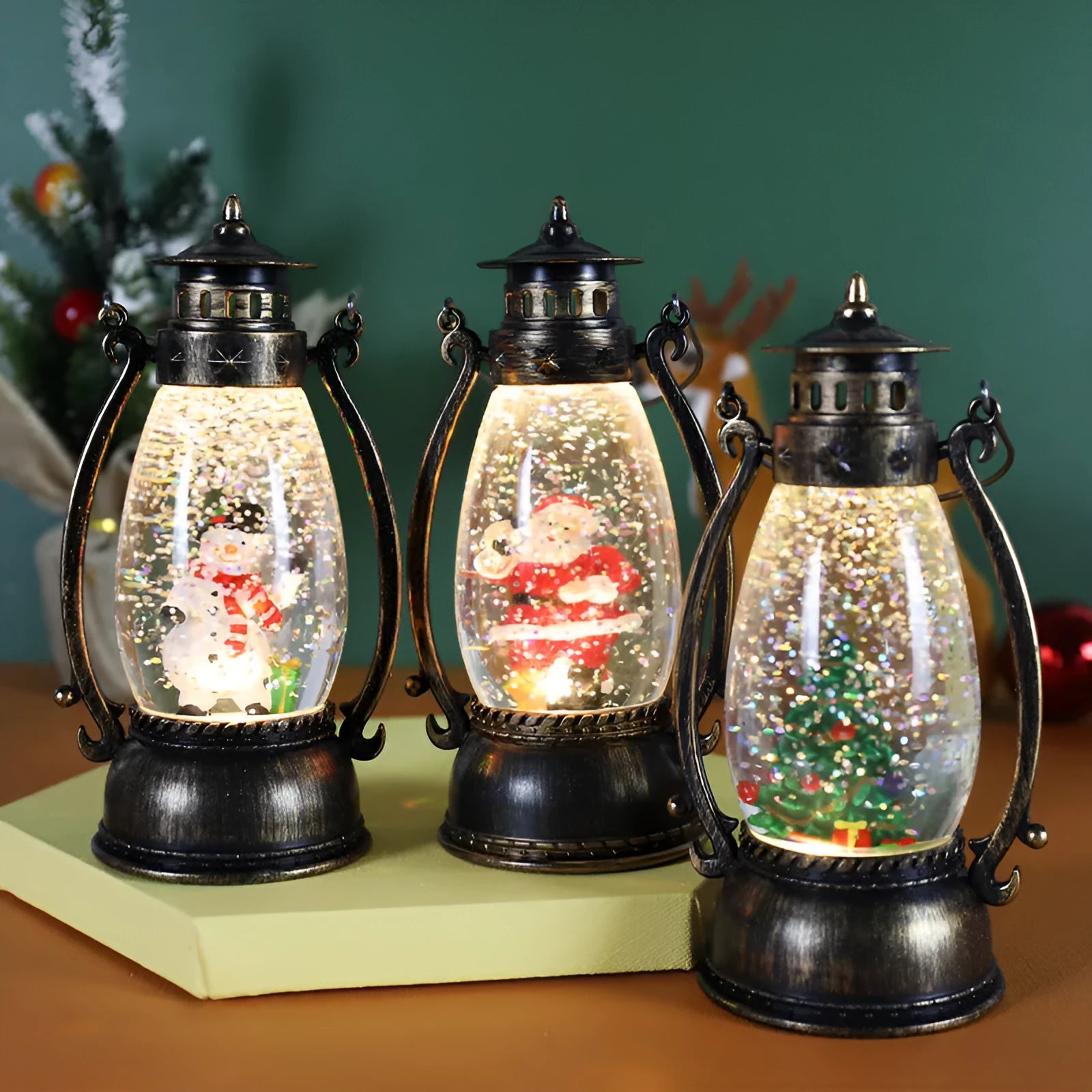 Plastic crystal ball LED oil lamp Christmas ornament with internal snowman figurine on a desktop.