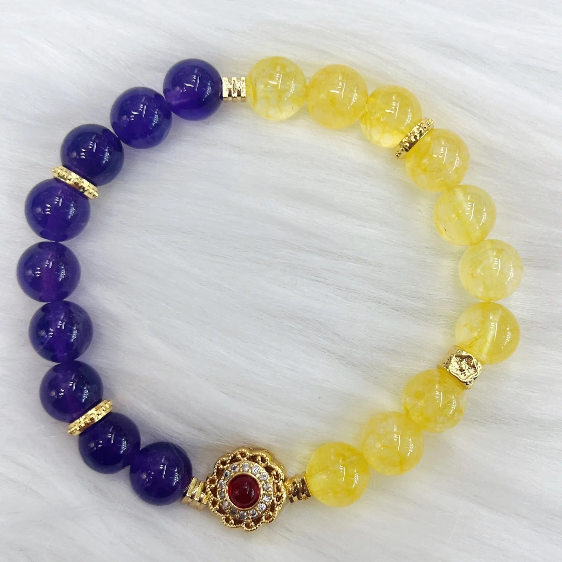 Handmade women's yellow and purple crystal bracelet with amethyst beads on wrist