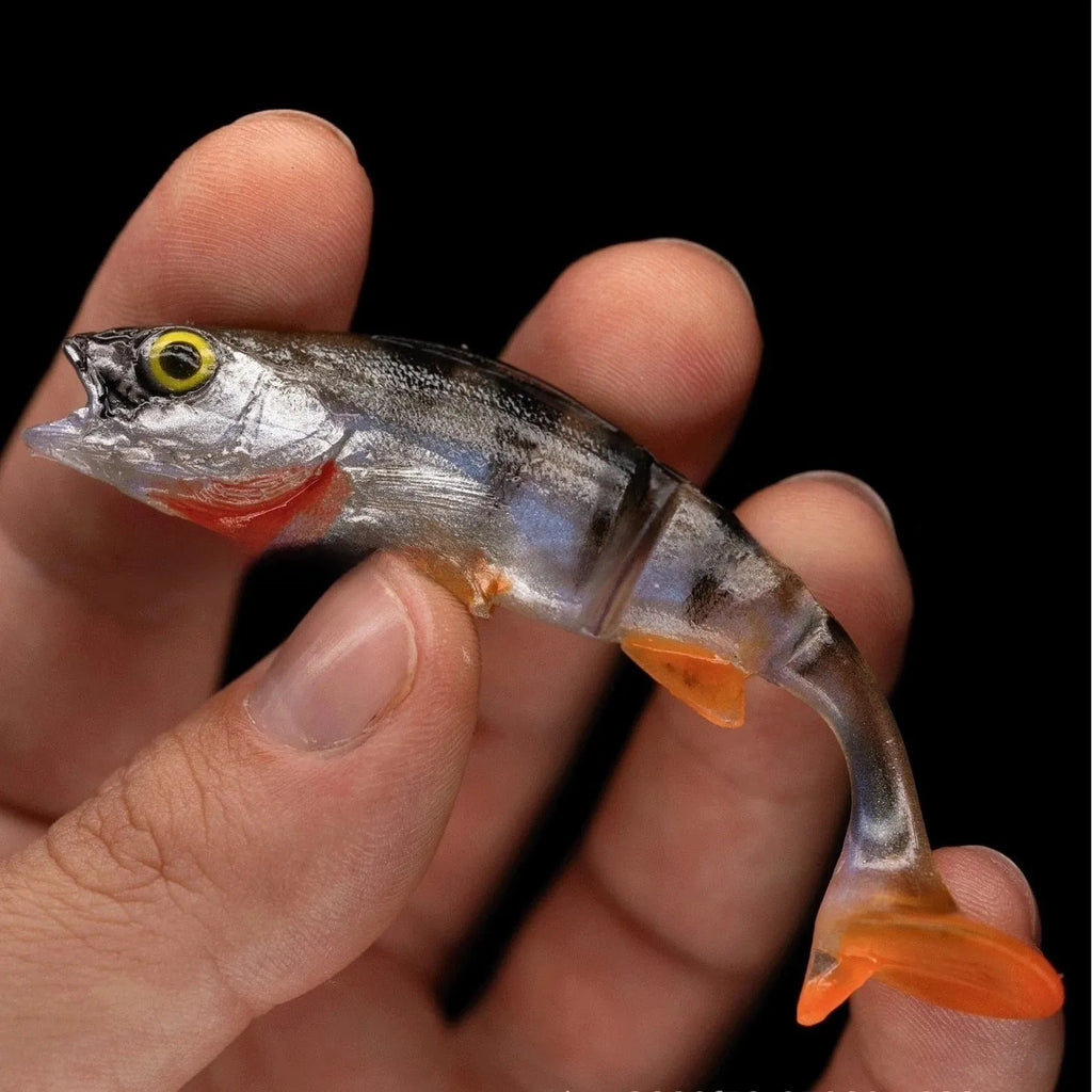 7cm long soft fishing lure designed as a catfish imitation with a T-tail, in a fish colour pattern.