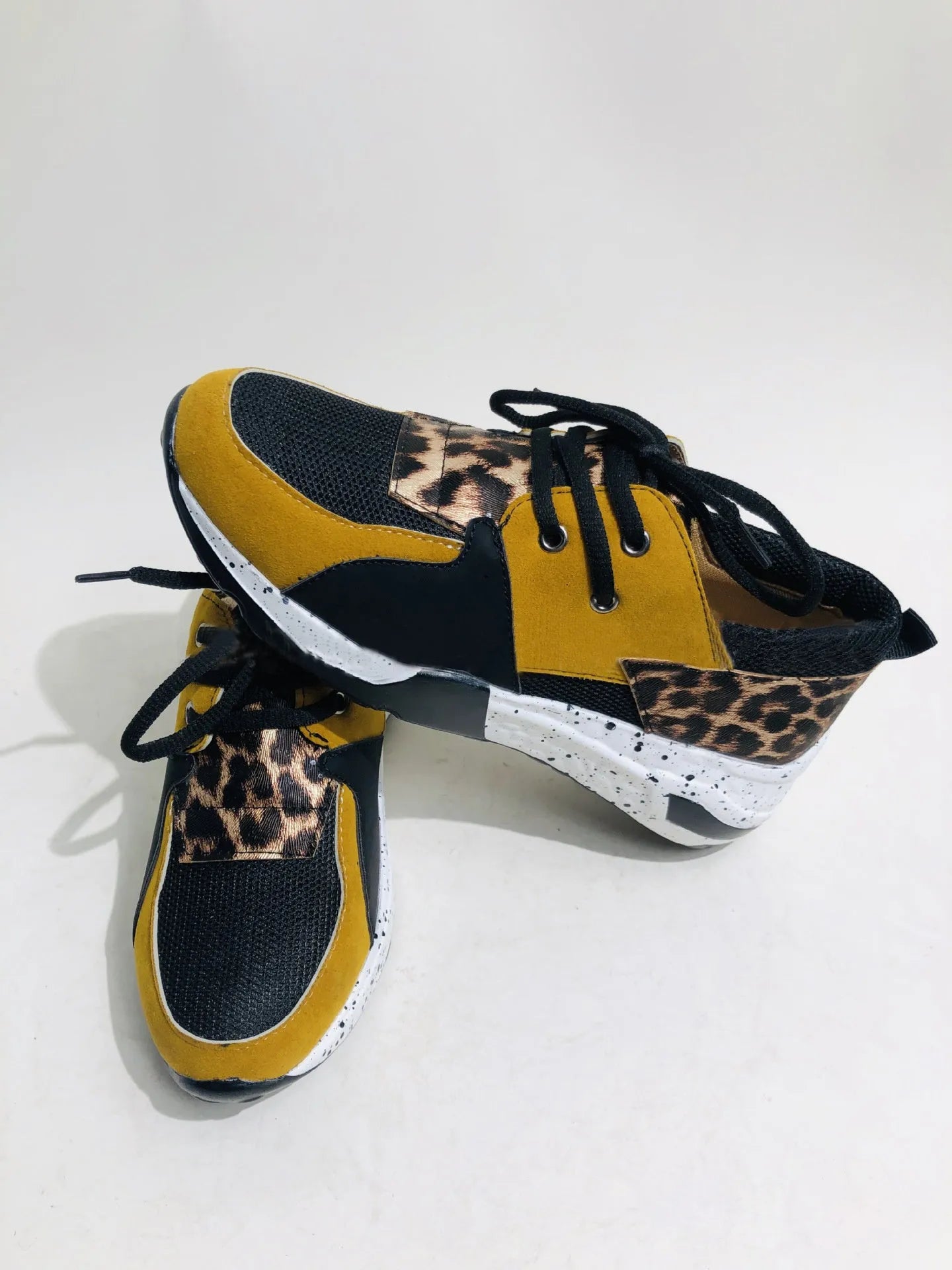 Women's casual suede flat sneakers with wedge heel in black, leopard, pink, panther, and snake pattern options.