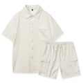 Beige elastic waist shorts and short sleeve top two-piece set laid flat.