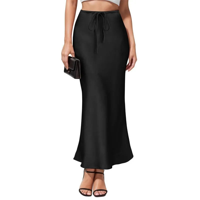 High-waisted acetate satin asymmetric skirt in a solid colour on a model