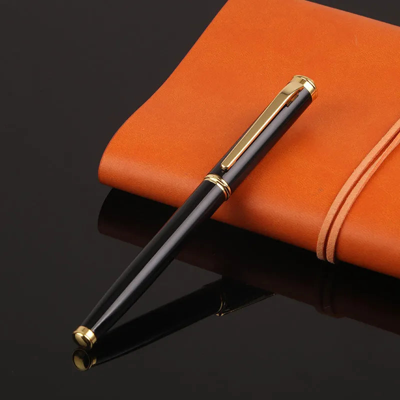 Red and black metal fountain pen with a 0.5mm Yijin nib on a writing surface.