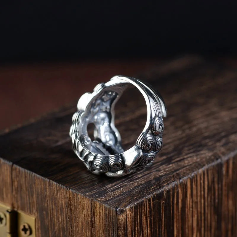 Detailed silver open ring featuring an animal zodiac beast pattern on a model's finger.