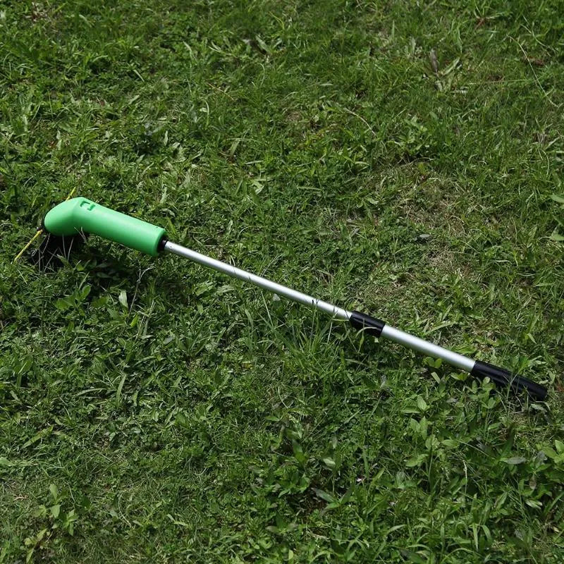 Cordless handheld lawn trimmer with extension pole and protective debris shield on a lawn.