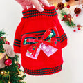 Red Christmas sweater for a dog on a festive background, showing the knit pattern and fit.