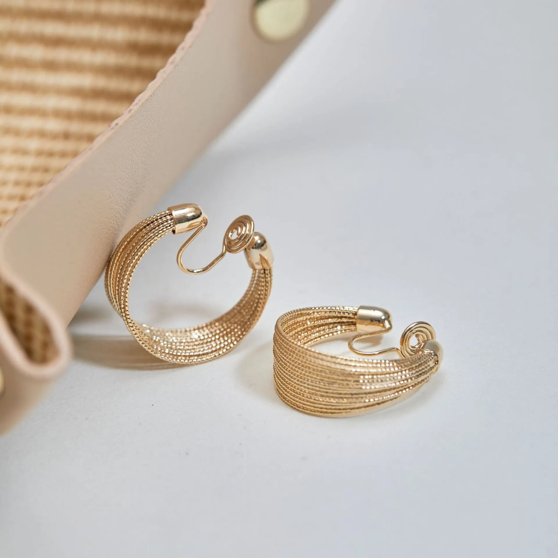 Geometric multi-layer copper earrings with silver or gold electroplated finish, showing stud and clip options