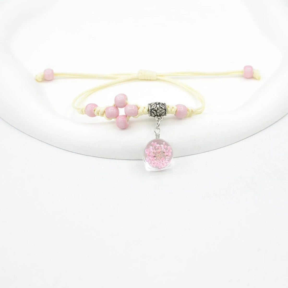 Glass dried flower bracelet for women with large 1.4cm bead and lace charm in multiple colour choices.