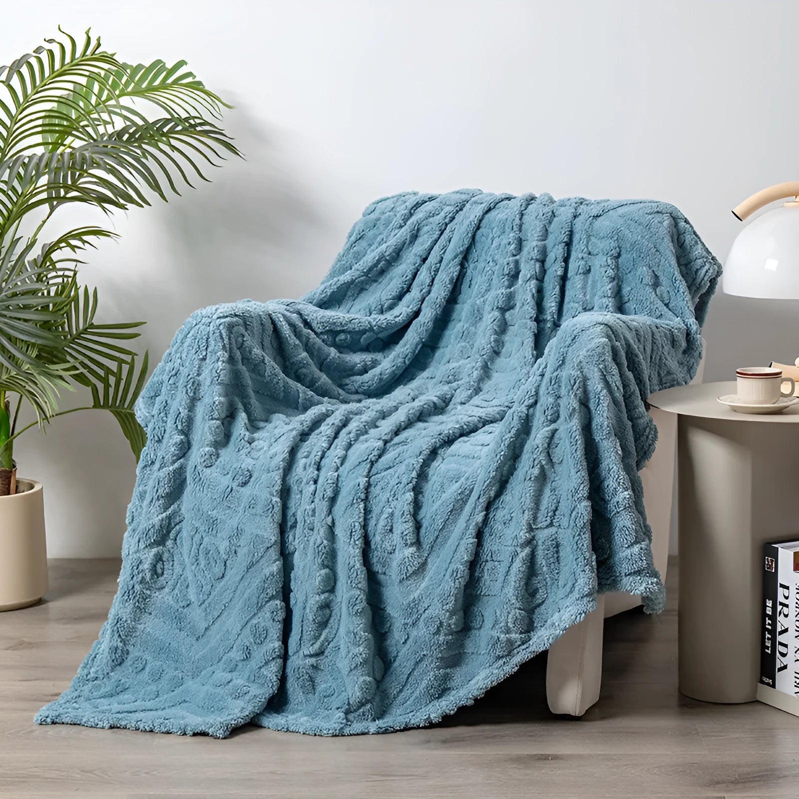 Shu cotton velvet jacquard sofa blanket in a solid colour draped over a modern sofa