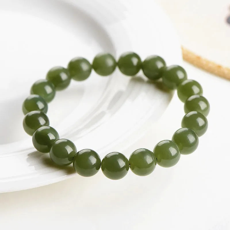 Polished Hetian jade ball bracelet showing spherical beads on a wrist, available in deep or shallow ice-clear colours.