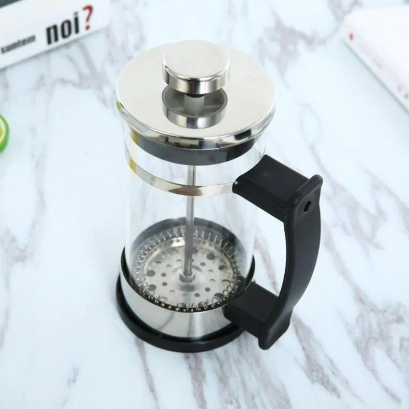Compact glass stovetop coffee maker with stainless steel components, shown with dimensions 10cm wide and 17cm high.