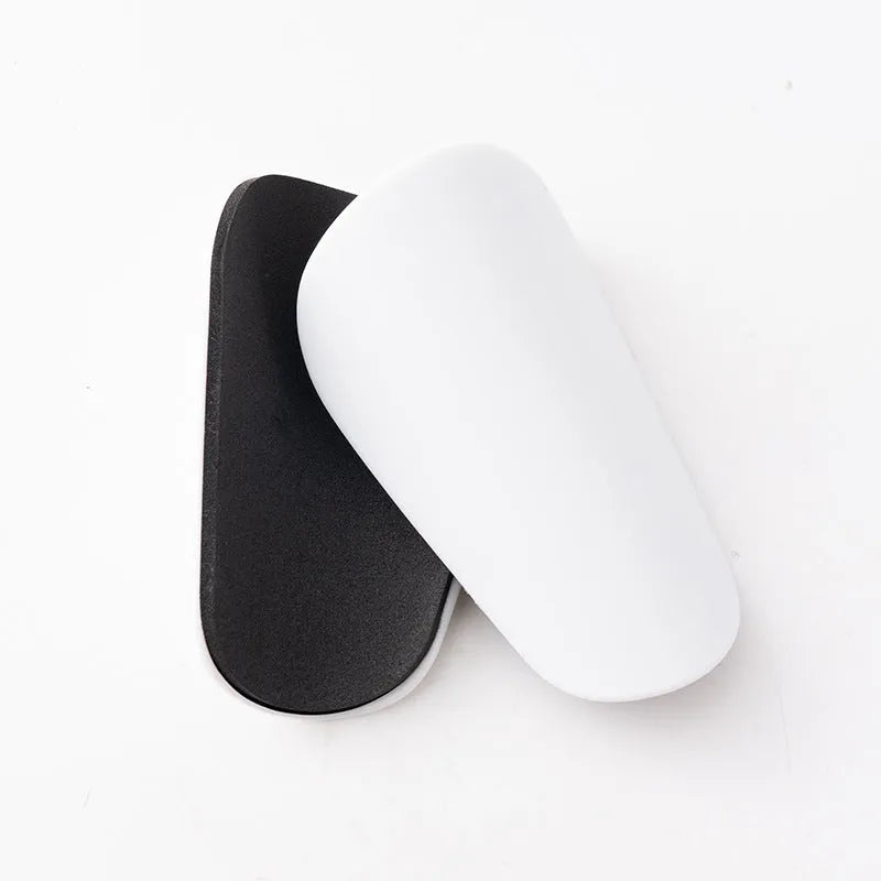 PU mini shin guards in various colours on a leg, showing S and XS sizing for sports protection.