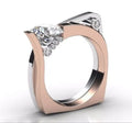 Rose gold geometric couple ring with a central zircon stone inlay on a model's hand.