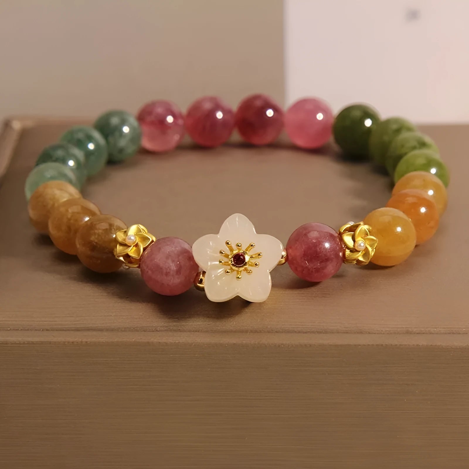 Natural colour tourmaline bracelet with floral and fu character designs on geometric casual jewellery