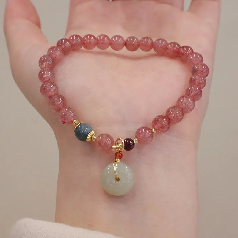 Women's geometric strawberry quartz bracelet with Chinese purse charm and safety buckle clasp.