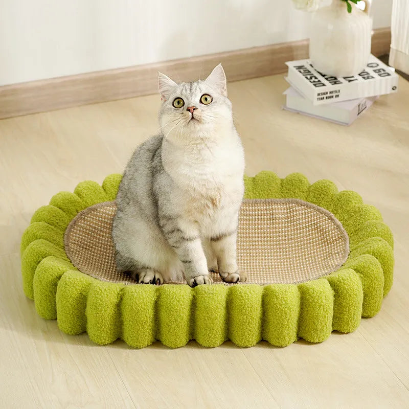Green oval-shaped sisal cat scratching pad lounge bed on a floor.