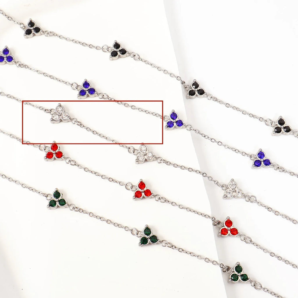 Geometric triangle bracelet for women in stainless steel with coloured zircon stones.