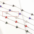 Geometric triangle bracelet for women in stainless steel with coloured zircon stones.