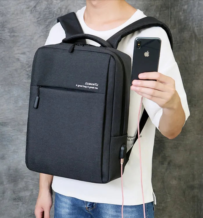 Black waterproof rechargeable laptop backpack with shoulder straps, showing front compartment