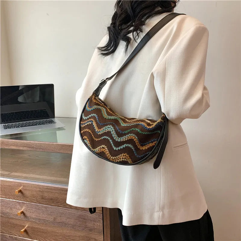 Women's straw woven crossbody bag showing internal mobile phone pocket and file compartment.
