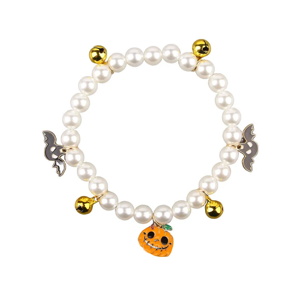 Halloween pet collar charm with simulated pearls and a choice of pumpkin or ghost decoration.