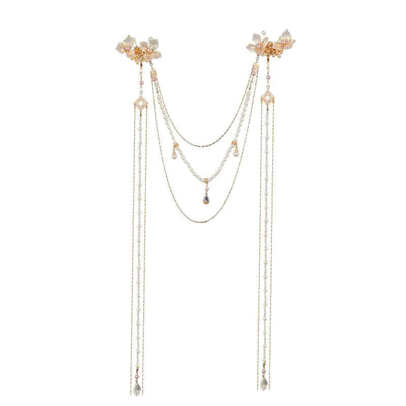 Gold coloured women's hairpin with a pearl, diamond flower and long decorative tassels.