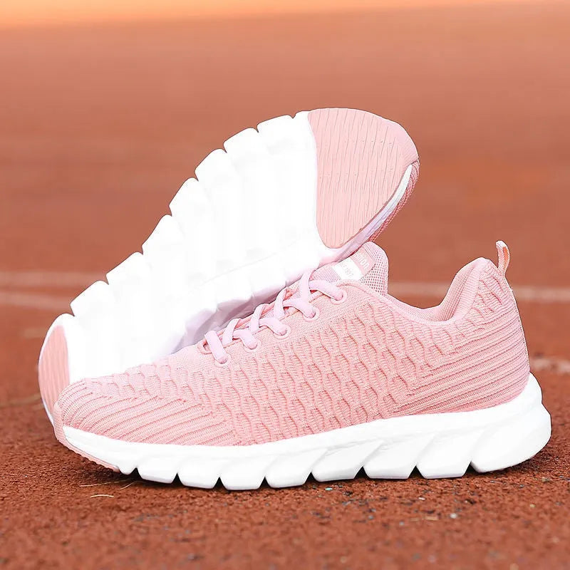 Women's running shoes in black, pink, and white with fly weaving upper and wear-resistant outsole