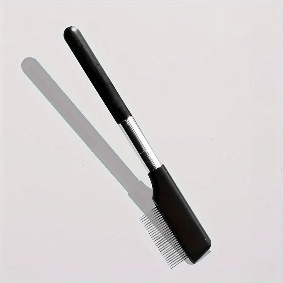 Black handheld pet grooming brush with a soft silicone head for eye tear stain removal.