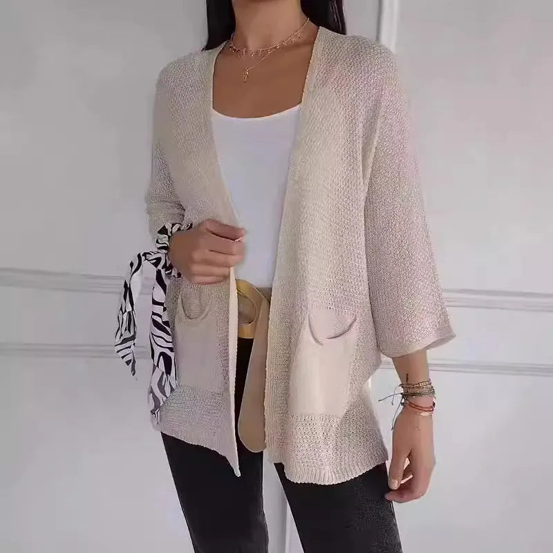 Women's army green waffle knit cardigan coat with nine-quarter sleeves and pockets.
