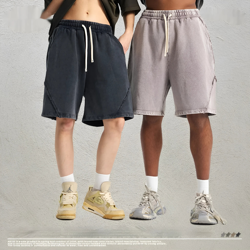 Man wearing loose-fit batik washed cotton terry shorts in a retro style with patch craft details.