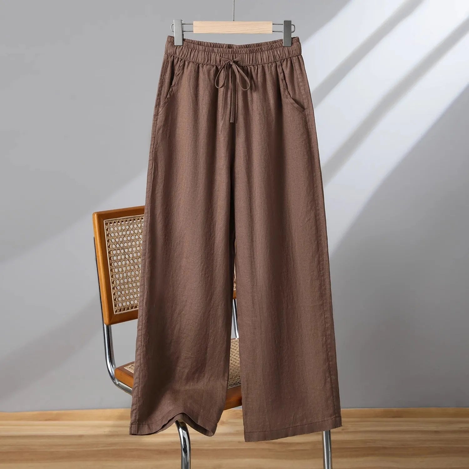 Women's straight-leg casual trousers in apricot colour with an elastic and drawstring waistband.