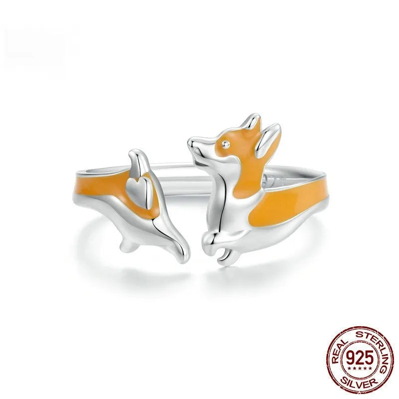 Adjustable silver ring with a raised cartoon corgi dog design on the band.