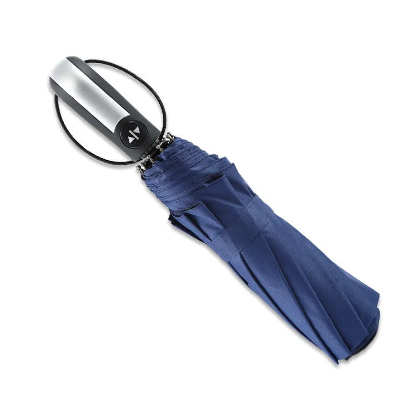 Black triple folding automatic business umbrella with steel ribs and a rubber handle.