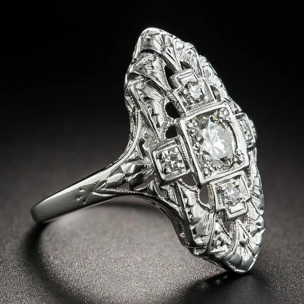 Geometric hollow out silver ring with diamond studs on a copper base.