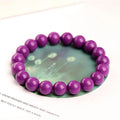Purple Mica crystal bracelet with polished beads in a single circle design on a wrist.